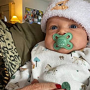 Adam a rejoint le concours — aidez-le/la à gagner de superbes lots ! animal_prints, baby, blanket, blue_eyes, child, closeup, cozy, cute, hand, home, indoor, infant, lamp, pacifier, person, portrait, red_nail_polish, soft_lighting, warm, white_hat