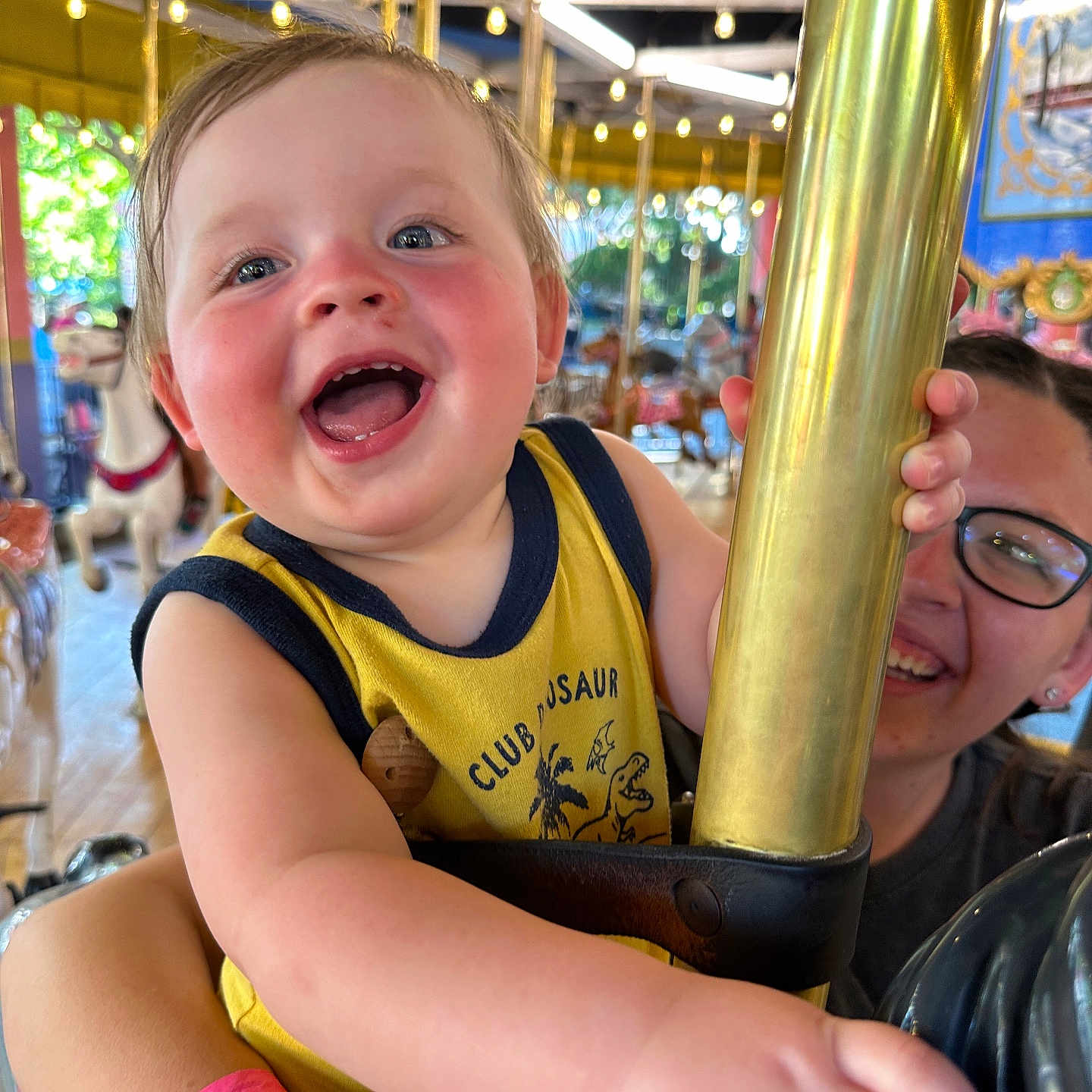 Westin is registered to the contest to win money with this photo: accessories, amusementpark, animal, baby, bodypart, carnival, carousel, clothing, face, finger, glasses, hand, head, horse, mouth, person, photography, play, portrait, t_shirt