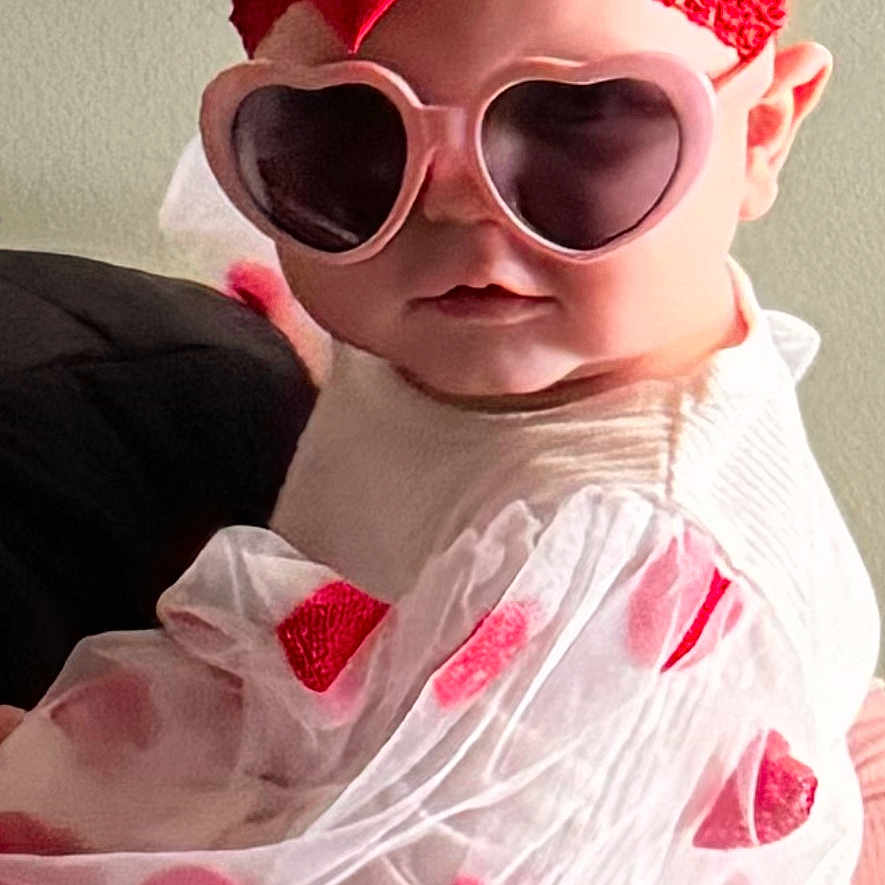 Nevaeh is registered to the contest to win money with this photo: accessories, baby, bodypart, cap, clothing, cosmetics, costume, face, finger, formalwear, glasses, goggles, hand, hat, head, lipstick, person, photography, portrait, sunglasses