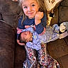 Aspen is registered to the contest to win money with this photo: baby, blanket, child, couch, cozy, cute, face, family, girl, happy, holding, home, indoor, newborn, patterned_clothing, portrait, sitting, sleeping, smiling, young_child