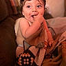 Lane Frost Chapman is registered to the contest to win money with this photo: baby, blanket, chewing, child, comfort, couch, cozy, cute, expression, face, hand, indoor, infant, pattern, person, portrait, sitting, soft_lighting, warm_colors, young_child