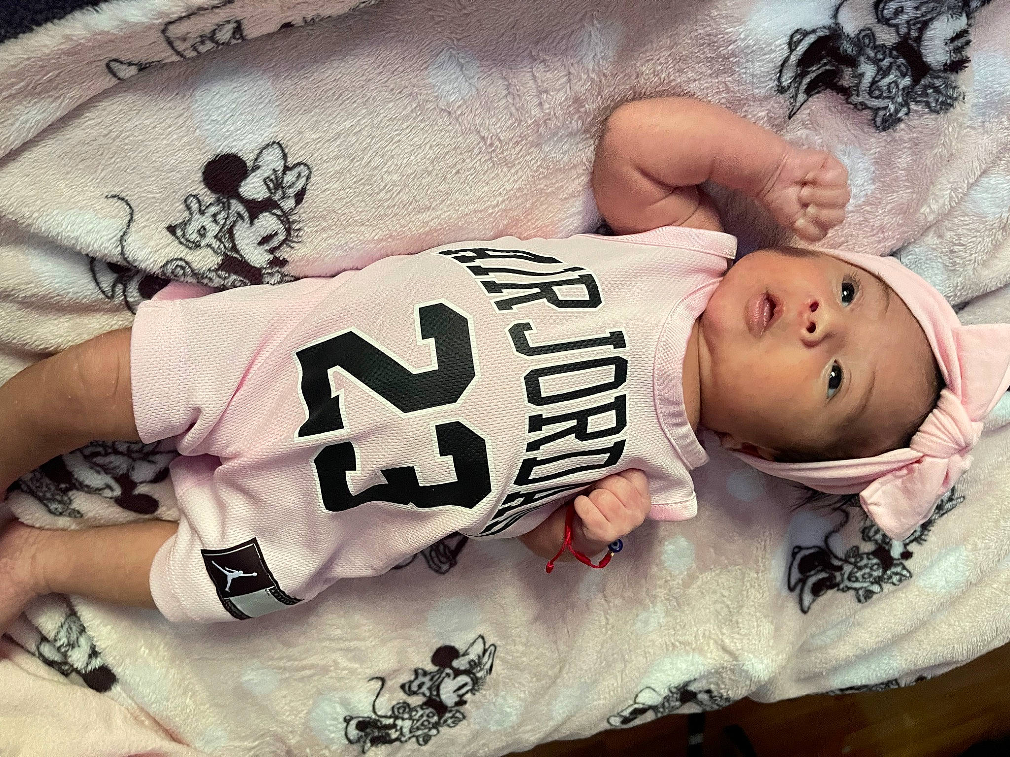 Natalia is registered to the contest to win money with this photo: abdomen, baby, chest, elbow, fashion_design, flesh, font, happy, human_leg, jersey, neck, pattern, person, sleeve, sportswear, t_shirt, tattoo, thigh, toddler, trunk