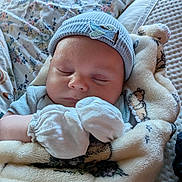 Weston joined the competition — help win amazing prizes! baby, sleeping, mittens, blanket, hat, infant, cozy, soft, bedspread, floral_pattern, cute, resting, peaceful, child, portrait, indoors, comfort, warm, newborn, closeup