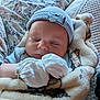 baby, sleeping, mittens, blanket, hat, infant, cozy, soft, bedspread, floral_pattern, cute, resting, peaceful, child, portrait, indoors, comfort, warm, newborn, closeup