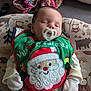 Weston is registered to the contest to win money with this photo: baby, pacifier, sleeping, bib, christmas, santa_claus, clothing, blanket, pillow, pattern, woodland_animals, indoor, cute, infant, holiday, soft_toys, cozy, child, face, sleep