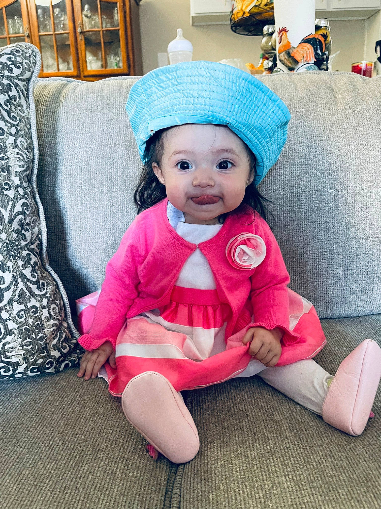 Kamila is registered to the contest to win money with this photo: baby, baby_toddler_clothing, cap, child, costume_hat, couch, fashion_accessory, floor, flooring, fur, hat, headgear, headwear, linens, magenta, person, pink, room, sitting, sleeve