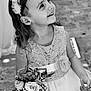child, girl, flower_bouquet, dress, lace, headband, smiling, portrait, black_and_white, happy, flower, wedding, outdoor, cute, person, young_child, celebration, accessory, holding, nature