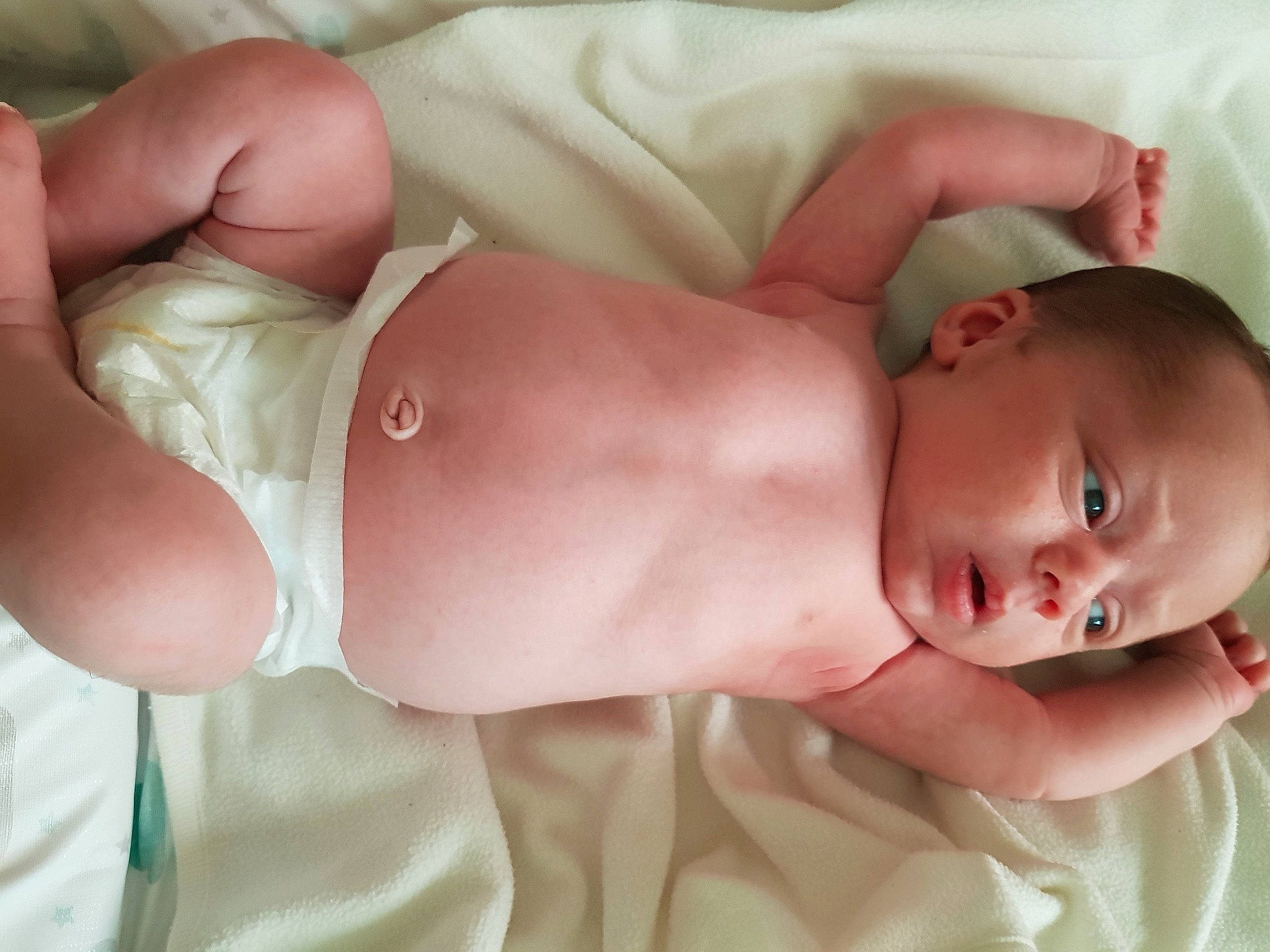 Arlo is registered to the contest to win money with this photo: abdomen, arm, baby, baby_sleeping, baby_toddler_clothing, cheek, chest, child, comfort, diaper, face, finger, human_body, mouth, muscle, person, pink, skin, stomach, thumb