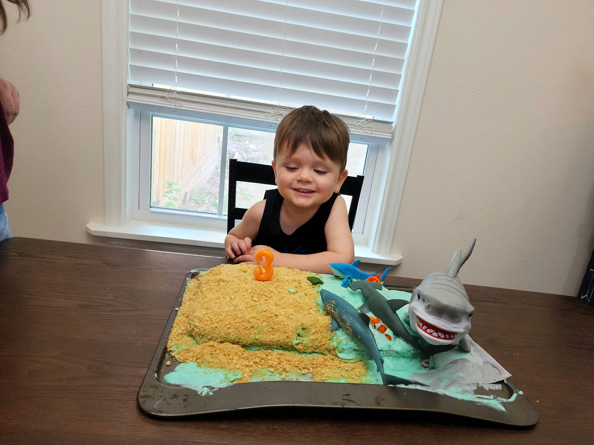 Justyn is registered to the contest to win money with this photo: baked_goods, baking, cake, cake_decorating, cake_decorating_supply, chair, child, cuisine, event, food, joy, person, plate, sharing, smile, sweetness, t_shirt, table, tableware, toddler