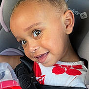 Kiara joined the competition — help win amazing prizes! toddler, child, car_seat, sippy_cup, smiling, curly_hair, safety_harness, close_up, indoors, seatbelt, red_and_white, cute, happy, person, portrait, baby, seat, head, hand, clothing