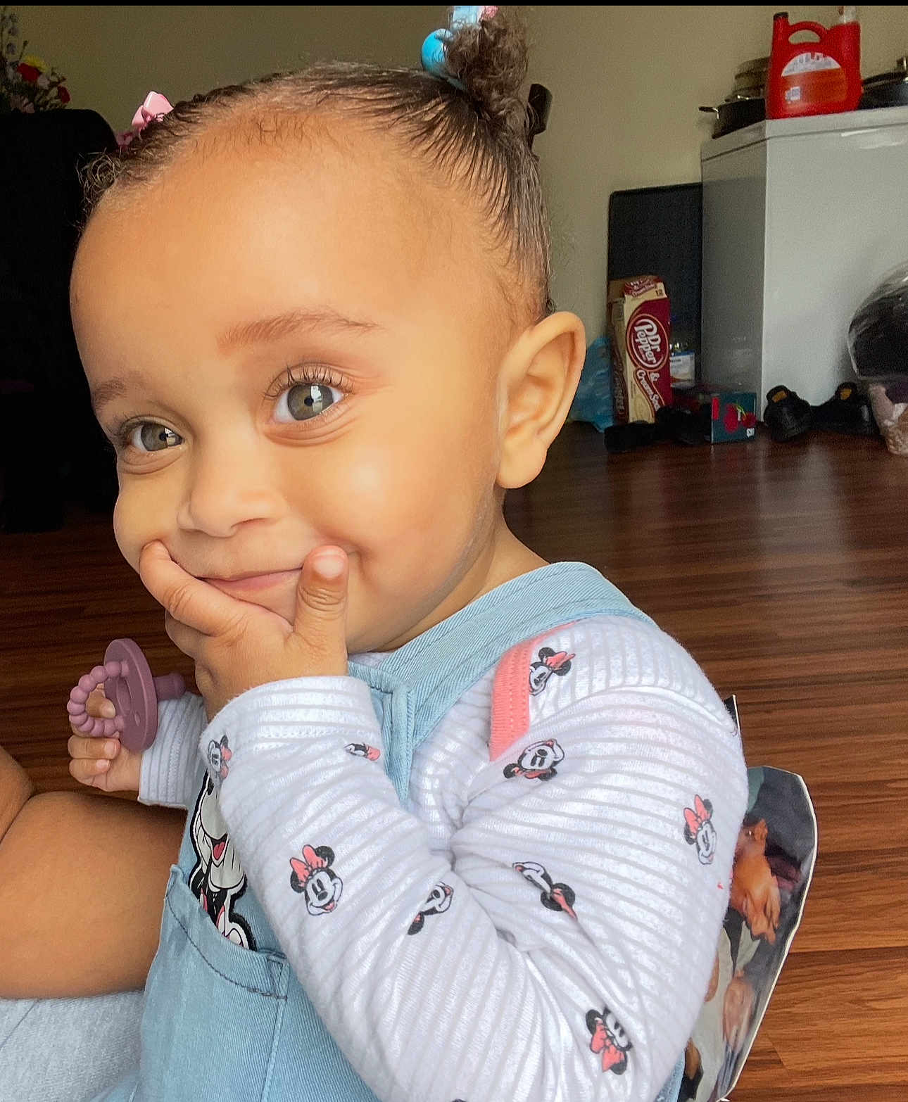 Kiara is registered to the contest to win money with this photo: child, toddler, smiling, cute, pacifier, minnie_mouse, clothing, indoor, floor, home, person, baby, hand, face, hair, toy, sitting, playful, expression, young