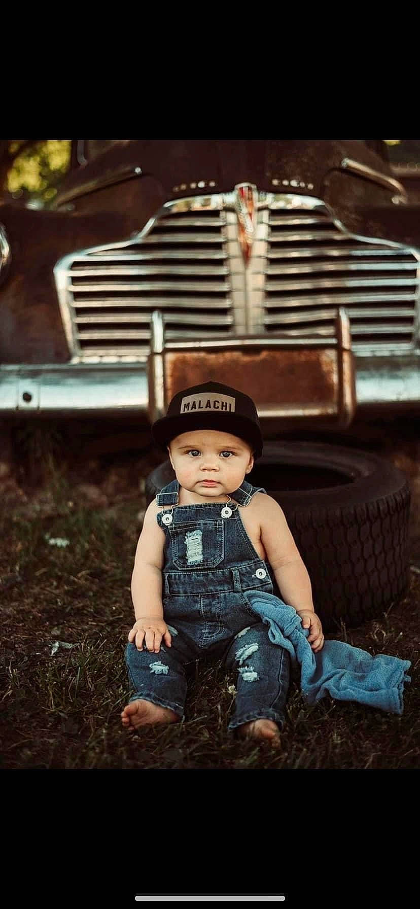 Malachi joined the competition — help win amazing prizes! automotive_design, automotive_exterior, automotive_lighting, automotive_tire, automotive_wheel_system, bumper, child, classic, flash_photography, grass, grille, hat, headgear, headlamp, headwear, hood, light, motor_vehicle, person, sun_hat