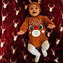 baby, infant, child, smile, happy, reindeer, costume, hat, blanket, pattern, red, white, cute, laying, legs, arms, face, cozy, warm, holiday