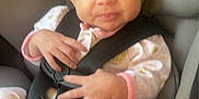 Ayla is registered to the contest to win money with this photo: baby, beads, car, car_seat, child, clothing, cute, expression, face, hand, head, indoor, infant, onesie, pacifier, person, safety, seatbelt, smiling, warning_label
