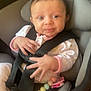 Ayla is registered to the contest to win money with this photo: baby, beads, car, car_seat, child, clothing, cute, expression, face, hand, head, indoor, infant, onesie, pacifier, person, safety, seatbelt, smiling, warning_label