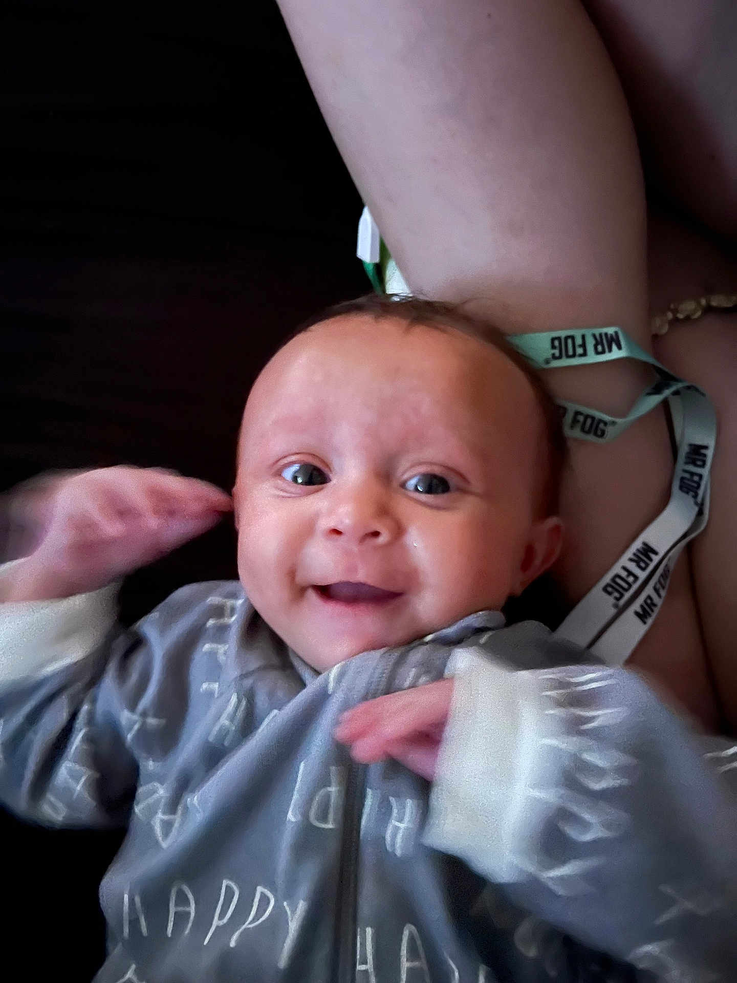 Ayla is registered to the contest to win money with this photo: baby, smiling, infant, clothing, onesie, hand, face, eyes, arm, wristband, text, happy, person, skin, portrait, indoor, cute, child, young, expression