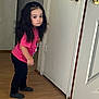 Amelia is registered to the contest to win money with this photo: black_pants, casual_clothing, child, curious, door, doorknob, expression, floor, hair, home, indoor, long_hair, mickey_mouse, person, pink_tshirt, socks, standing, wall, wood_floor, young_child