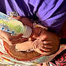 Nevaeh joined the competition — help win amazing prizes! baby, bottle, feeding, hand, blanket, clothing, person, infant, face, skin, newborn, bed, purple_cloth, footwear, carpet, fingers, comfort, indoor, human, nurturing
