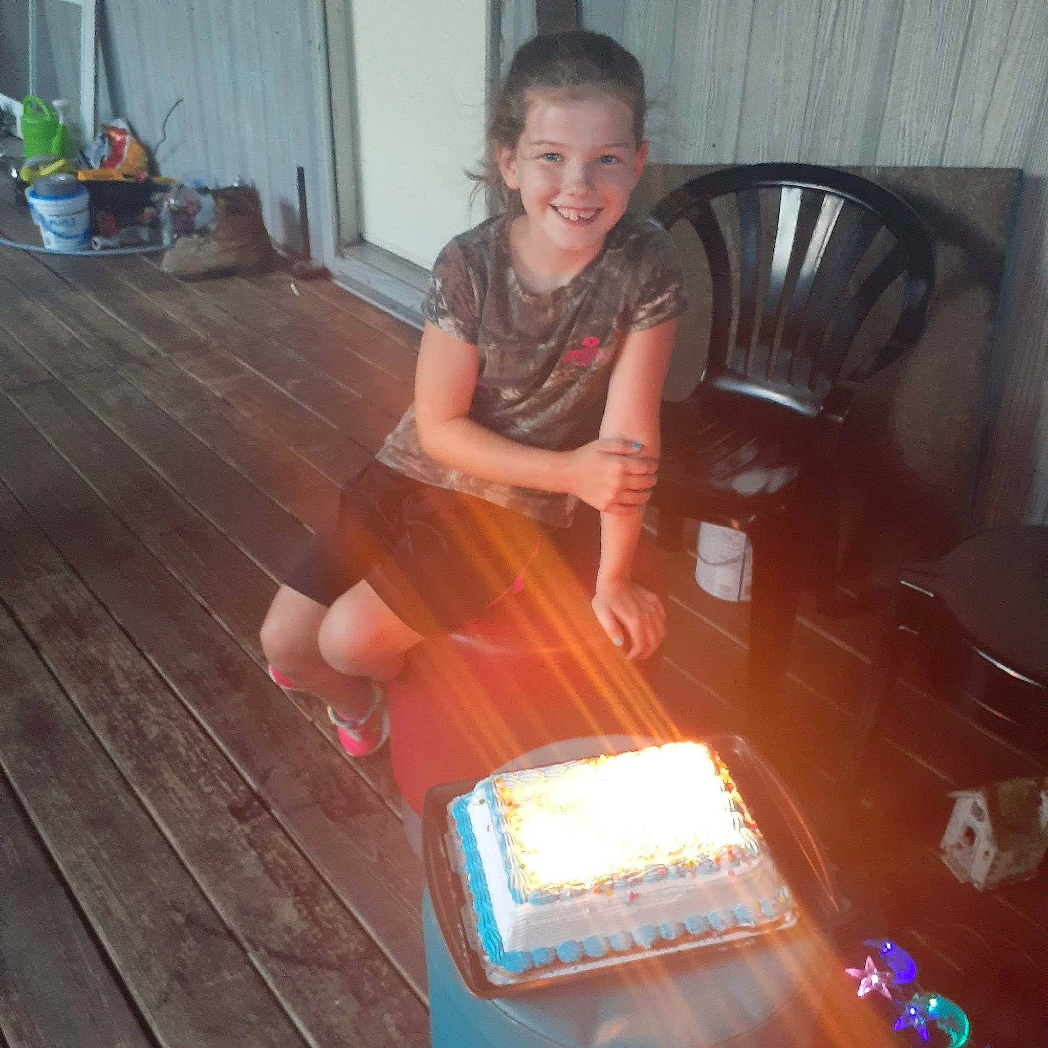 Ashley joined the competition — help win amazing prizes! birthday_cake, candle, chair, floor, flooring, flowerpot, food, hardwood, houseplant, indoor_games_and_sports, joy, laminate_flooring, person, plant, room, sitting, smile, table, varnish, wood