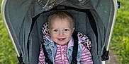 Alaura-Jane joined the competition — help win amazing prizes! toddler, child, stroller, smile, blue_eyes, outdoor, pathway, grass, toy, colorful, coat, jacket, blanket, safety_strap, baby_toy, happy, portrait, person, daylight, casual