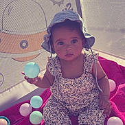 Elaïa participe au concours pour gagner de l'argent avec cette photo : baby, blanket, child, childrens_toy, colorful_balls, cute, floor, hat, indoors, infant, looking_at_camera, play, playpen, portrait, sitting, smiling, soft_toys, sun_hat, toy, young_child