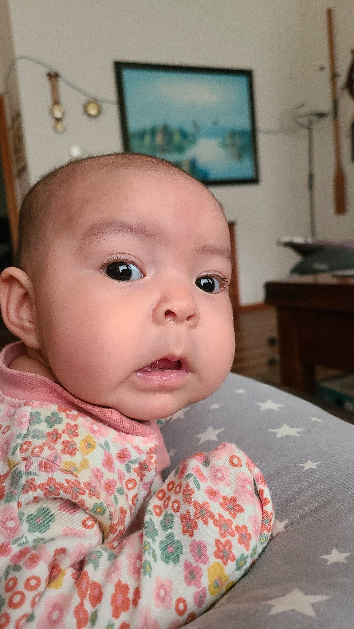 Audrey is registered to the contest to win money with this photo: baby, baby_toddler_clothing, chair, cheek, child, collar, comfort, eye, eyebrow, eyelash, iris, lip, nose, pattern, person, picture_frame, room, sitting, sleeve, table