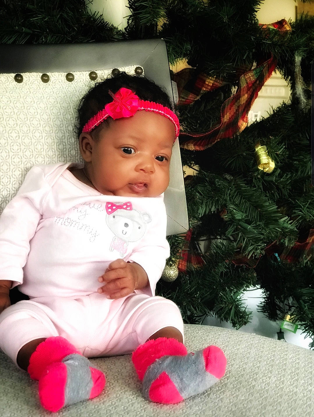 Karmyn is registered to the contest to win money with this photo: baby, baby_toddler_clothing, beauty, child, christmas, christmas_eve, person, pink, sitting, skin, toddler