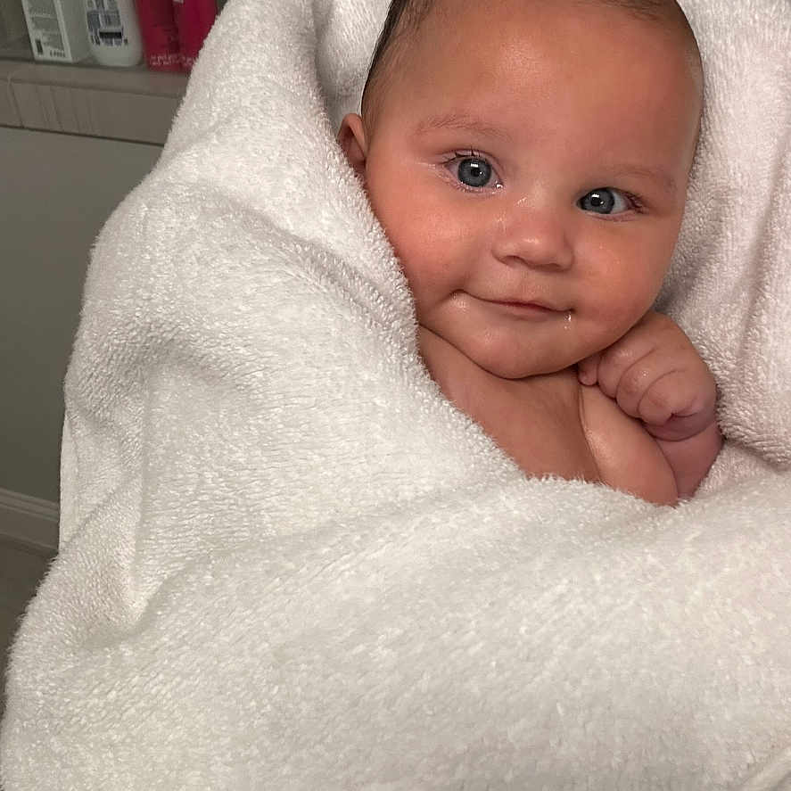 Mia is registered to the contest to win money with this photo: architecture, baby, blanket, bodypart, building, face, finger, furniture, hand, happy, head, hospital, newborn, person, photography, portrait, quilt, sleeping, smile, towel