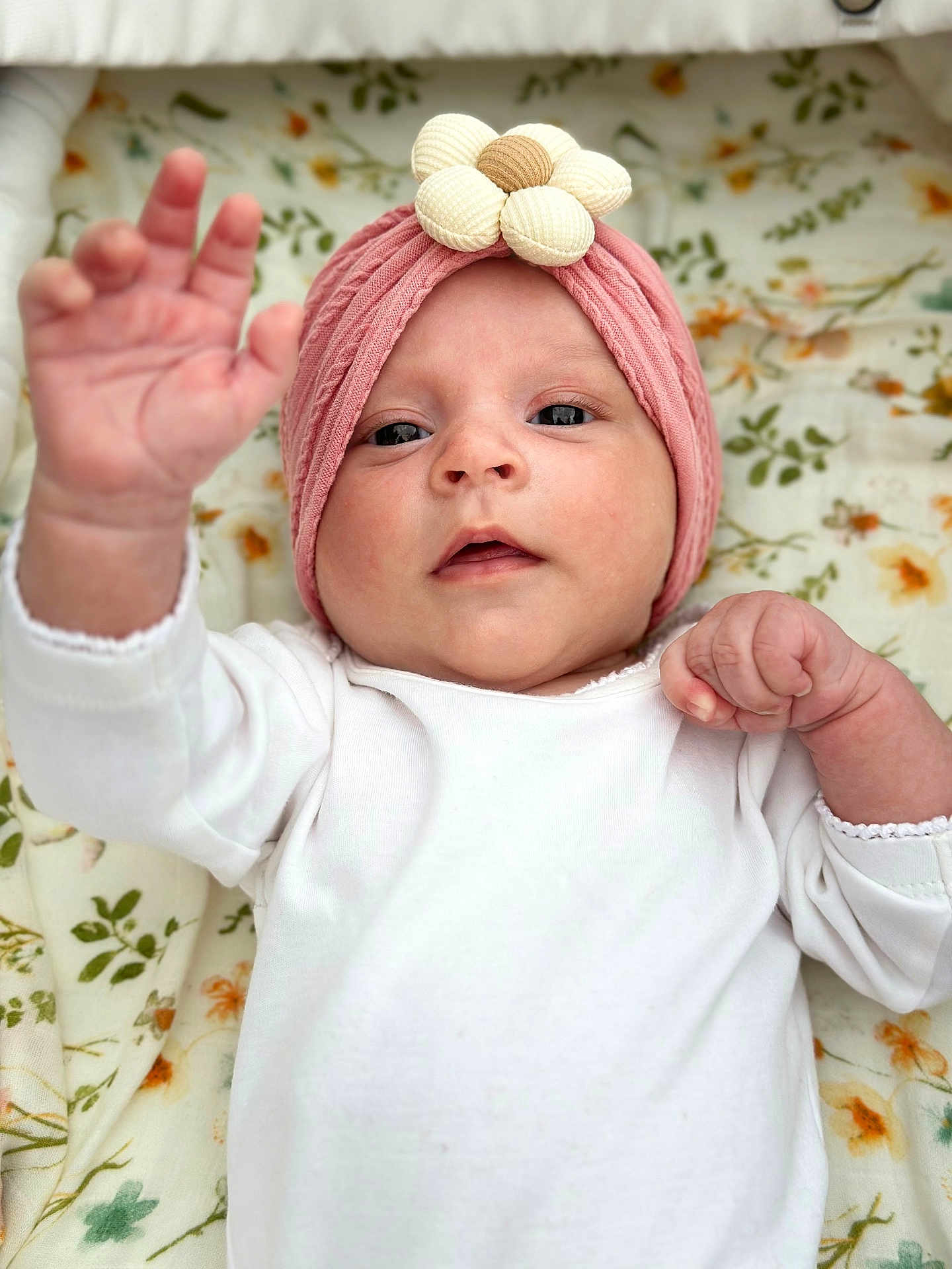Sienna is registered to the contest to win money with this photo: baby, infant, child, headband, flower, pink, white_clothing, hand, face, eyes, blanket, floral_pattern, cute, portrait, lying_down, skin, newborn, soft_light, closeup, indoors