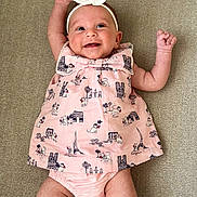 Sienna is registered to the contest to win money with this photo: adorable, arms_up, baby, bow, carpet, cat_pattern, child, clothing, cute, diaper, happy, headband, indoors, infant, lying_down, paris_theme, pink_dress, portrait, smile, young_child