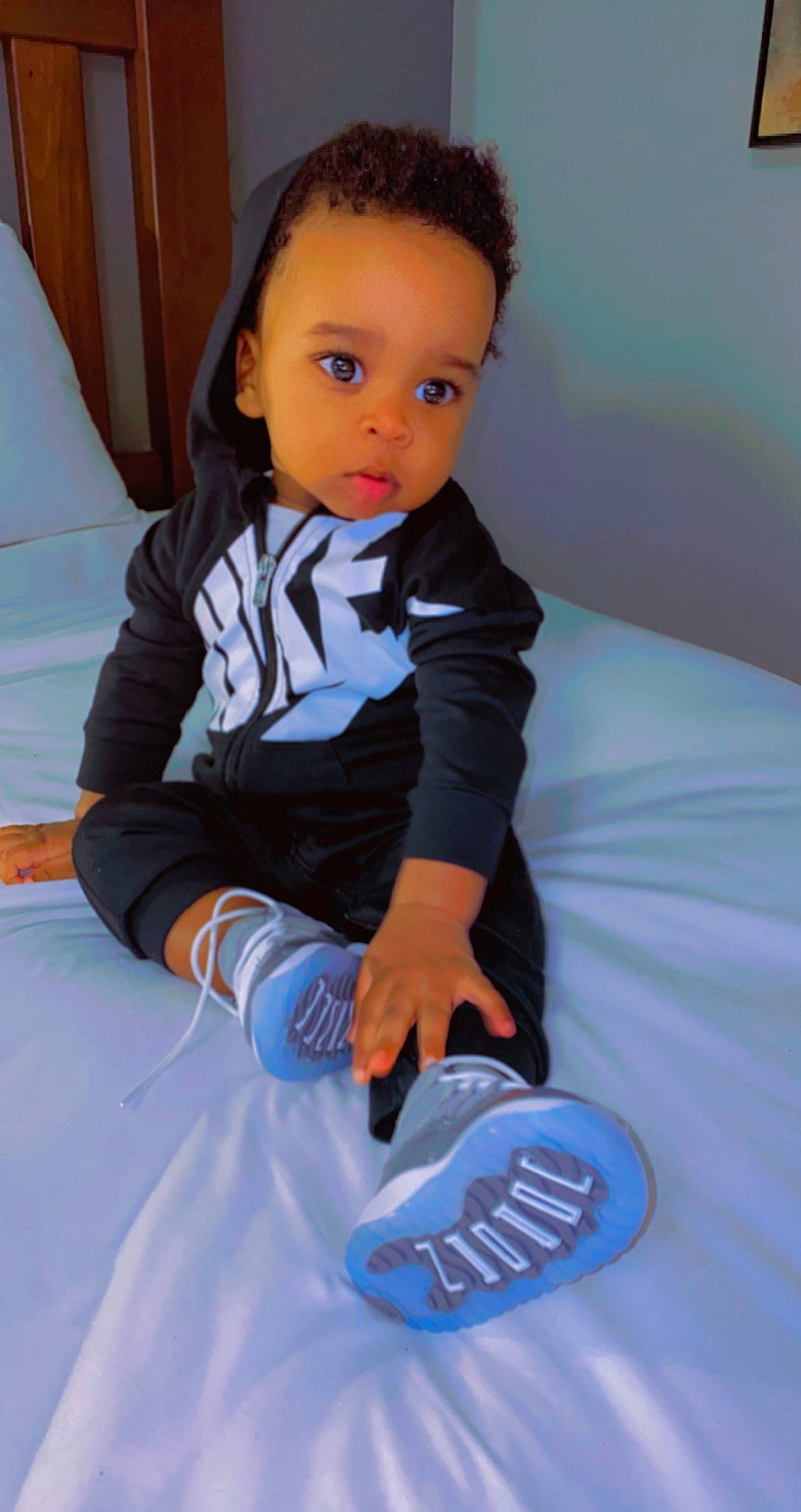 Caleb is registered to the contest to win money with this photo: arm, baby, baby_toddler_clothing, child, comfort, electric_blue, eye, flooring, formal_wear, fun, hairstyle, knee, leisure, person, play, sitting, sleeve, sneakers, sportswear, tie