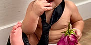 Kingston is registered to the contest to win money with this photo: baby, barefoot, child, curious, cute, diaper, expression, floor, flower, foot, hand, indoors, infant, pink_flower, portrait, sitting, skin, tie, wall, young