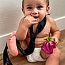 Kingston is registered to the contest to win money with this photo: baby, child, diaper, tie, flower, hand, foot, skin, floor, wall, curious, indoors, sitting, cute, portrait, infant, pink_flower, barefoot, expression, young