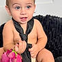toddler, child, baby, blue_eyes, black_tie, rose, flower, sitting, bare_chest, skin, hands, smile, indoor, blanket, plush, cute, portrait, young_child, soft_light, background