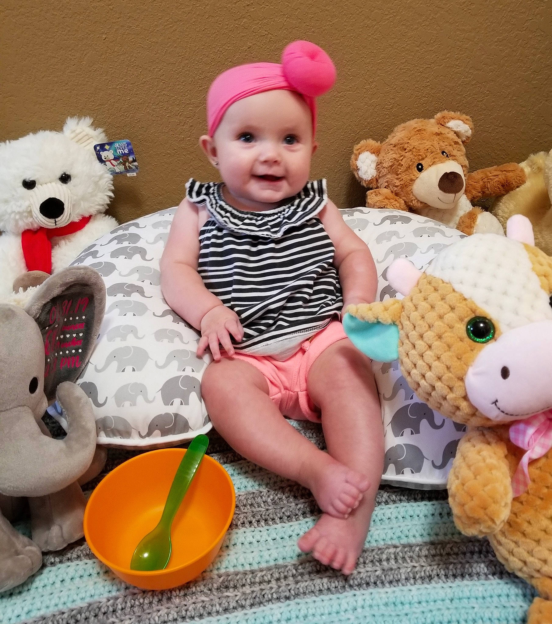 Macie is registered to the contest to win money with this photo: baby, baby_toys, beanie, cap, child, happy, head, headgear, person, play, plush, product, room, smile, stuffed_toy, teddy_bear, toddler, toy, yellow