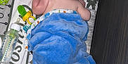 Grayson is registered to the contest to win money with this photo: baby, blanket, bottle, toy, playmat, infant, child, floor, blue_blanket, pacifier, colorful_toys, sleeping_baby, soft_texture, wooden_floor, patterned_mat, lying_down, back_view, cute, small_arms, indoor