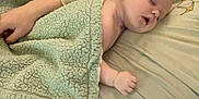 Grayson is registered to the contest to win money with this photo: baby, sleeping, blanket, person, hand, bed, pillow, comfort, rest, peaceful, infant, skin, clothing, nap, cozy, toddler, indoor, human, young, care
