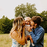 Grayson joined the competition — help win amazing prizes! baby, child, young_adult, family, kissing, outdoor, meadow, flowers, trees, nature, love, affection, portrait, summer, grass, casual_clothing, happy, holding, people, daylight