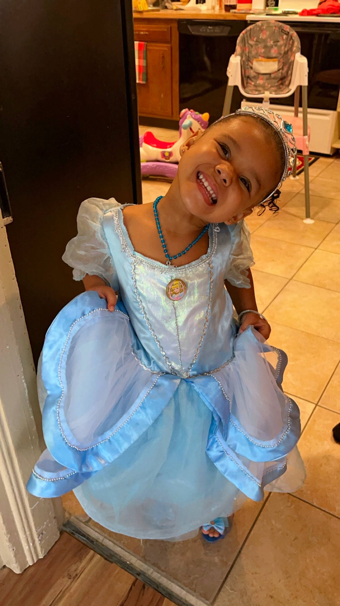 Amara joined the competition — help win amazing prizes! baby_toddler_clothing, chair, child, costume, dress, embellishment, event, face, fashion_design, flooring, formal_wear, fun, happy, joy, person, ruffle, sandal, sitting, skin, smile