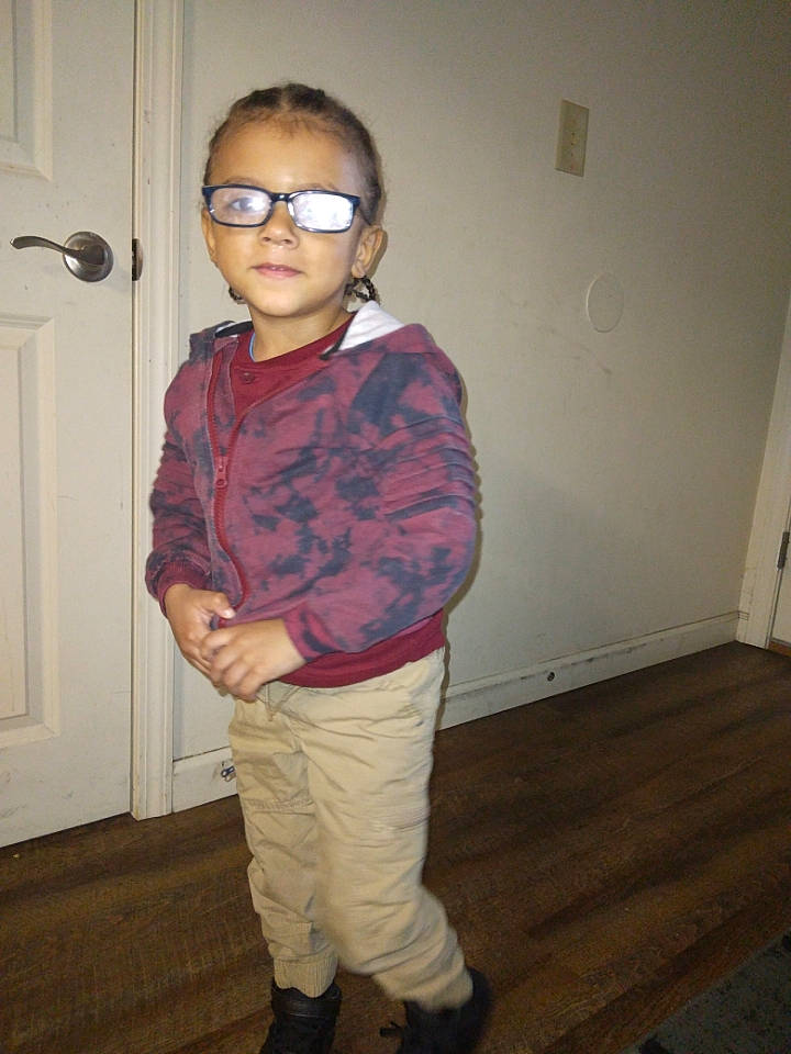 Enoch is registered to the contest to win money with this photo: baby_toddler_clothing, door, eyewear, fashion_design, floor, flooring, goggles, hairstyle, hardwood, knee, pattern, person, sleeve, standing, street_fashion, sunglasses, toddler, vision_care, wood, wood_flooring