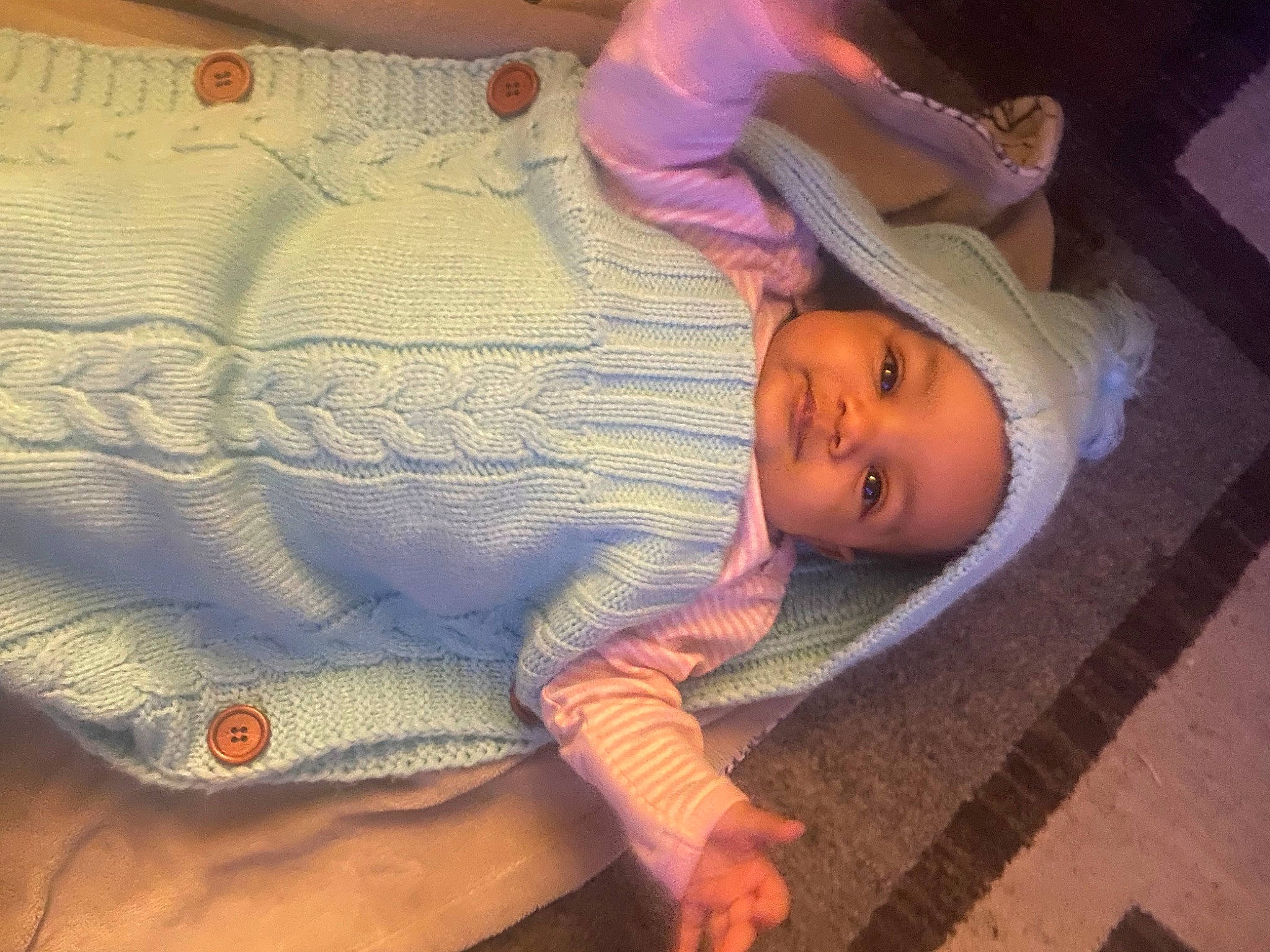 Aquinnah is registered to the contest to win money with this photo: baby, baby_toddler_clothing, cheek, child, cloud, comfort, eye, head, headwear, human_body, iris, linens, lip, nose, person, pink, purple, skin, smile, textile