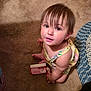 Rileigh joined the competition — help win amazing prizes! toddler, child, carpet, indoor, person, toy, card, strawberry_shortcake, curly_hair, looking_up, barefoot, yellow_dress, patterned_clothing, braided_rug, home, cute, young_child, playtime, floor, small_person