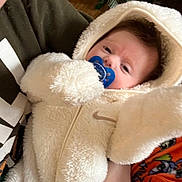 Alessia joined the competition — help win amazing prizes! baby, pacifier, onesie, hood, fluffy, infant, person, clothing, hand, fabric, soft, cute, child, sitting, warm, indoor, portrait, face, expression, holding