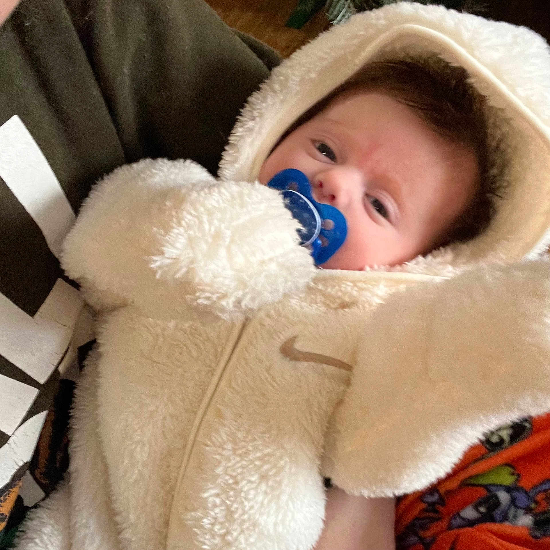 Alessia joined the competition — help win amazing prizes! baby, child, clothing, cute, expression, fabric, face, fluffy, hand, holding, hood, indoor, infant, onesie, pacifier, person, portrait, sitting, soft, warm