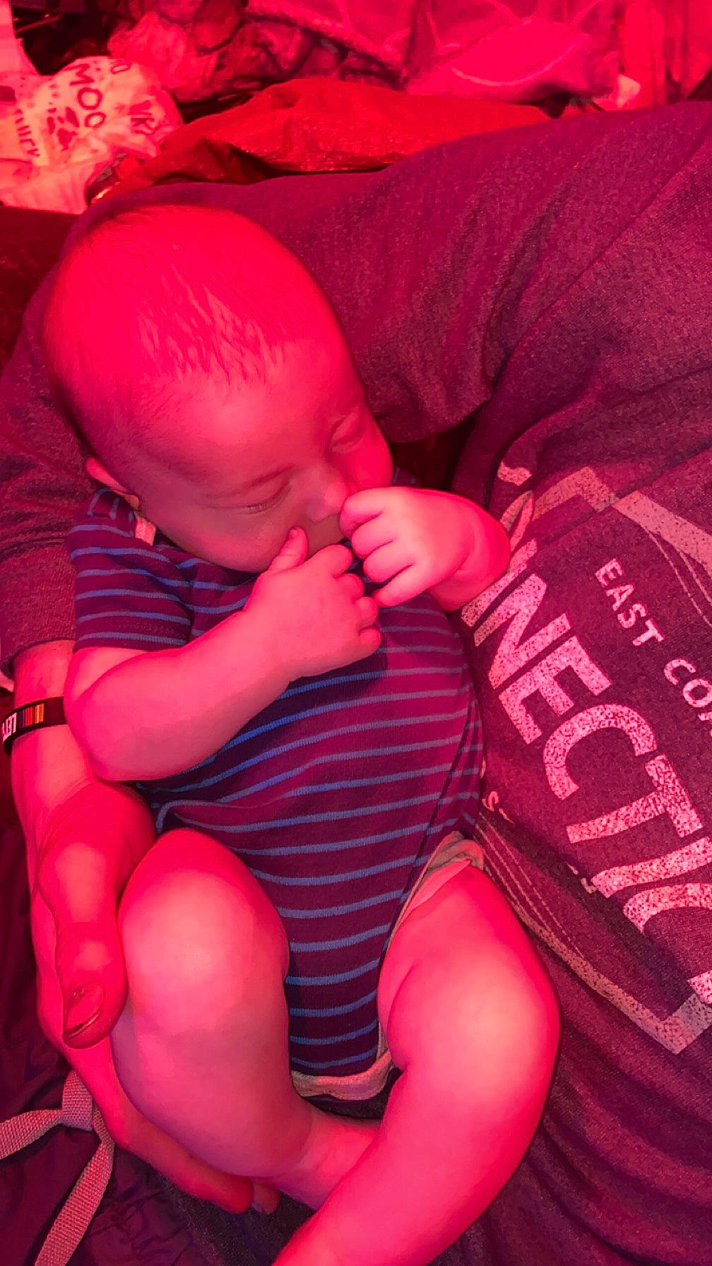 Shawn is registered to the contest to win money with this photo: arm, baby, comfort, finger, hand, human_body, interaction, joint, knee, lap, leg, mouth, muscle, nail, person, pink, shoulder, skin, stomach, textile