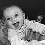 baby, baby_seat, black_and_white, child, clothing, cute, eyes, face, hand, happy, indoor, infant, joyful, monochrome, mouth, pattern, person, smiling, tongue, toy