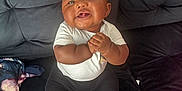 Kairo is registered to the contest to win money with this photo: baby, child, infant, couch, sofa, clothing, white_shirt, black_pants, booties, happy, smiling, hands, sitting, indoors, blanket, fabric, cute, joyful, plush, portrait