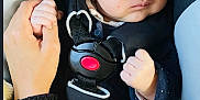 Souleymane a rejoint le concours — aidez-le/la à gagner de superbes lots ! baby, infant, car_seat, knit_hat, hand_holding, safety_belt, airbag_warning, black_clothing, cute, portrait, child, seat_belt, car_interior, person, closeup, face, young_child, warm_clothing, hat, indoor