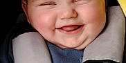 Scott joined the competition — help win amazing prizes! baby, smiling, face, child, car_seat, safety_harness, blue_clothing, yellow_blanket, happy, cute, infant, cheeks, tongue, closeup, portrait, young_child, seatbelt, baby_boy, joyful, cozy