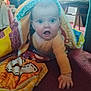 baby, child, quilt, blanket, carpet, indoor, furniture, hand, expression, colorful, person, crawling, room, upclose, curtain, chair, floor, head, clothing, infant